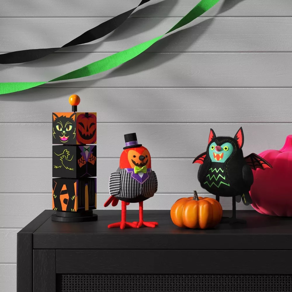 An assortment of Halloween Featherly Friends decorative bird figurines displayed on a table in a Target store