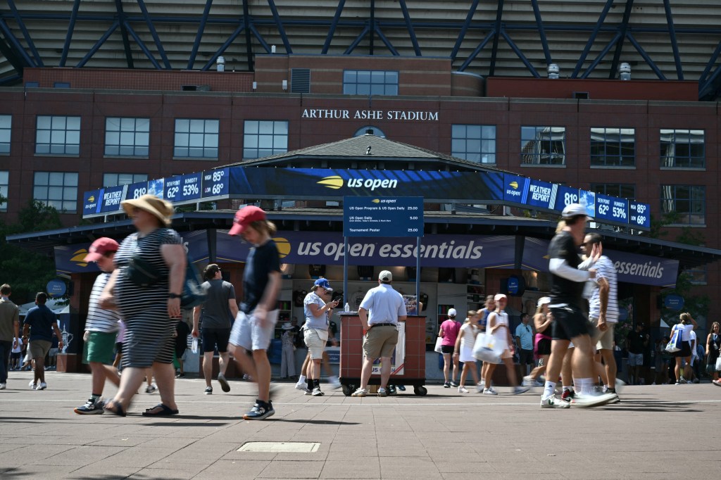 People walk past Arthur Ashe Stadium on the first day of the US Open tennis tournament at the USTA Billie Jean King National Tennis Center in New York on August 26, 2024